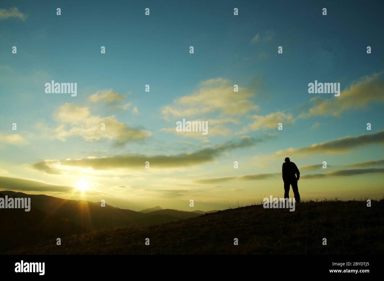 Men on sunset background Stock Photo - Alamy