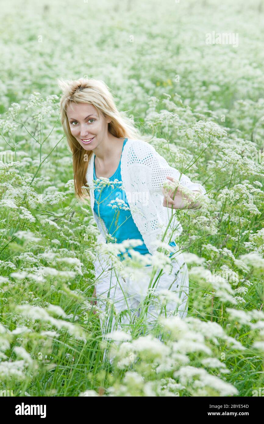 The happy young woman in the field of Stock Photo