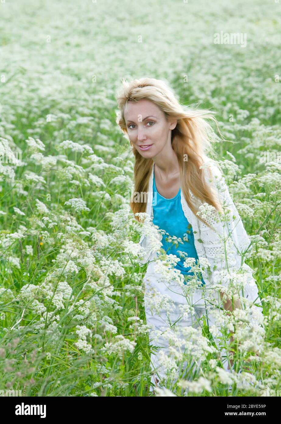 woman in the field of white wild flowers Stock Photo