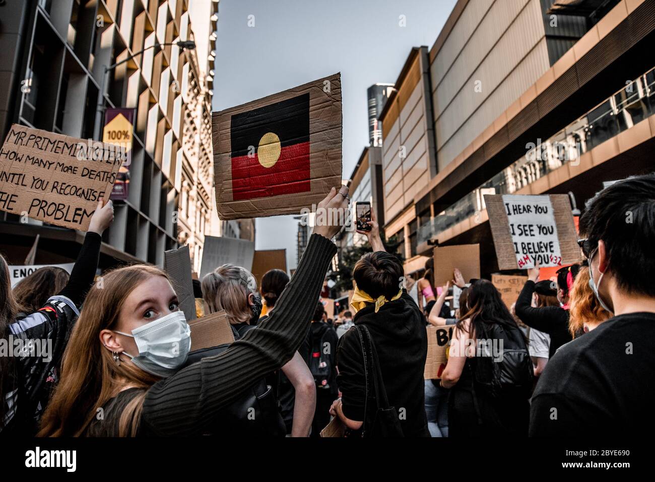 Young woman holds Aboriginal flag at BLM protest Stock Photo