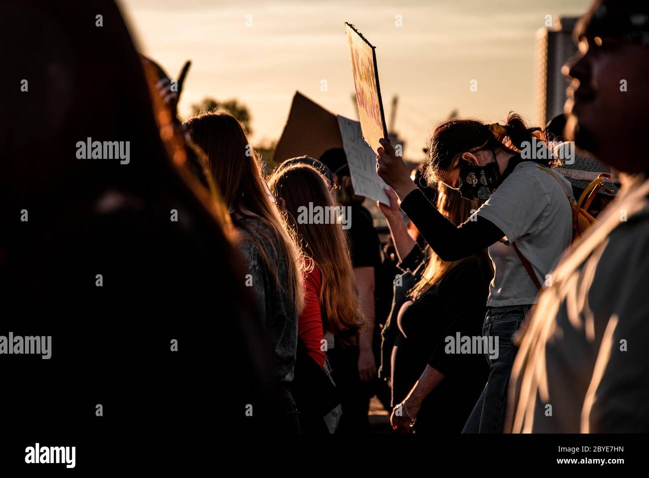 Young woman bows head at BLM protest Stock Photo
