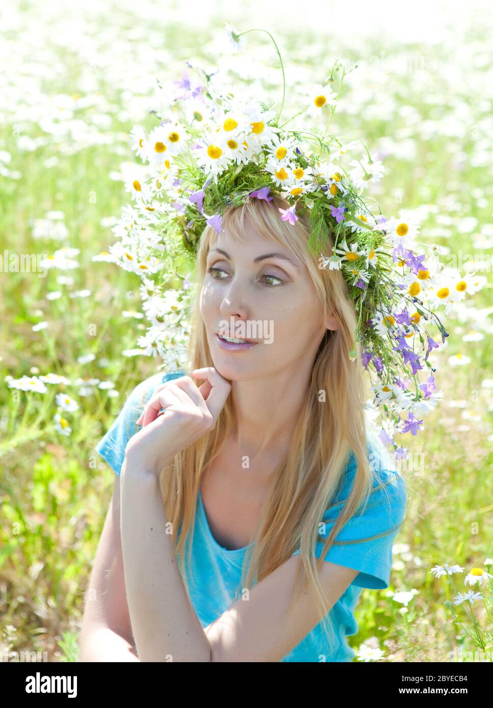 young woman in a wreath from wild flowers in the f Stock Photo