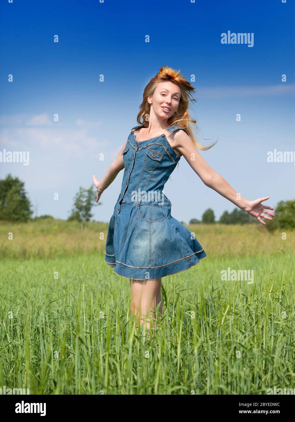 happy young woman in the field of green ears Stock Photo