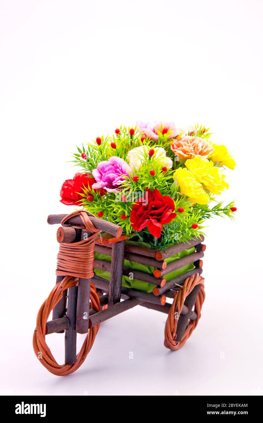 beautiful and colorful flower bouquet in wooden basket in car shape