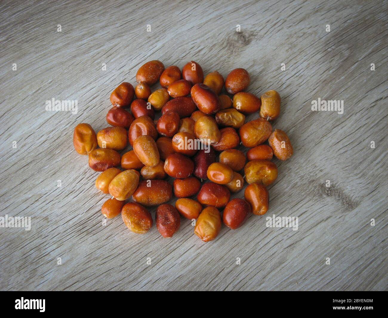 Dried fruit of Oleaster, Persian olive, Russian olive, silver berry, oleaster, or wild olive . Heap of dried fresh organic fruit of the Oleaster on wo Stock Photo