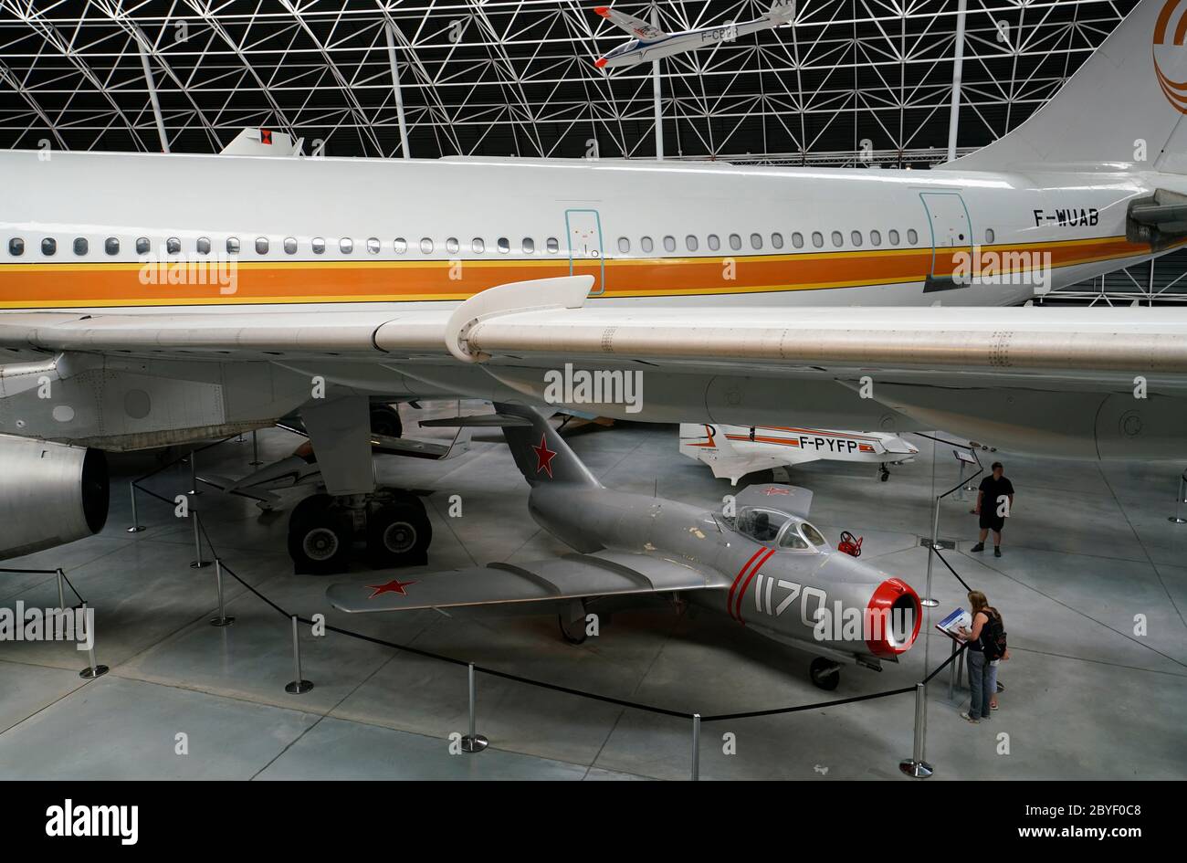 An Airbus A300B wide body airliner with a Soviet MiG-15 jet fighter display in Musee Aeroscopia Museum. Blagnac.Toulouse.Haute-Garonne.Occitanie.France Stock Photo