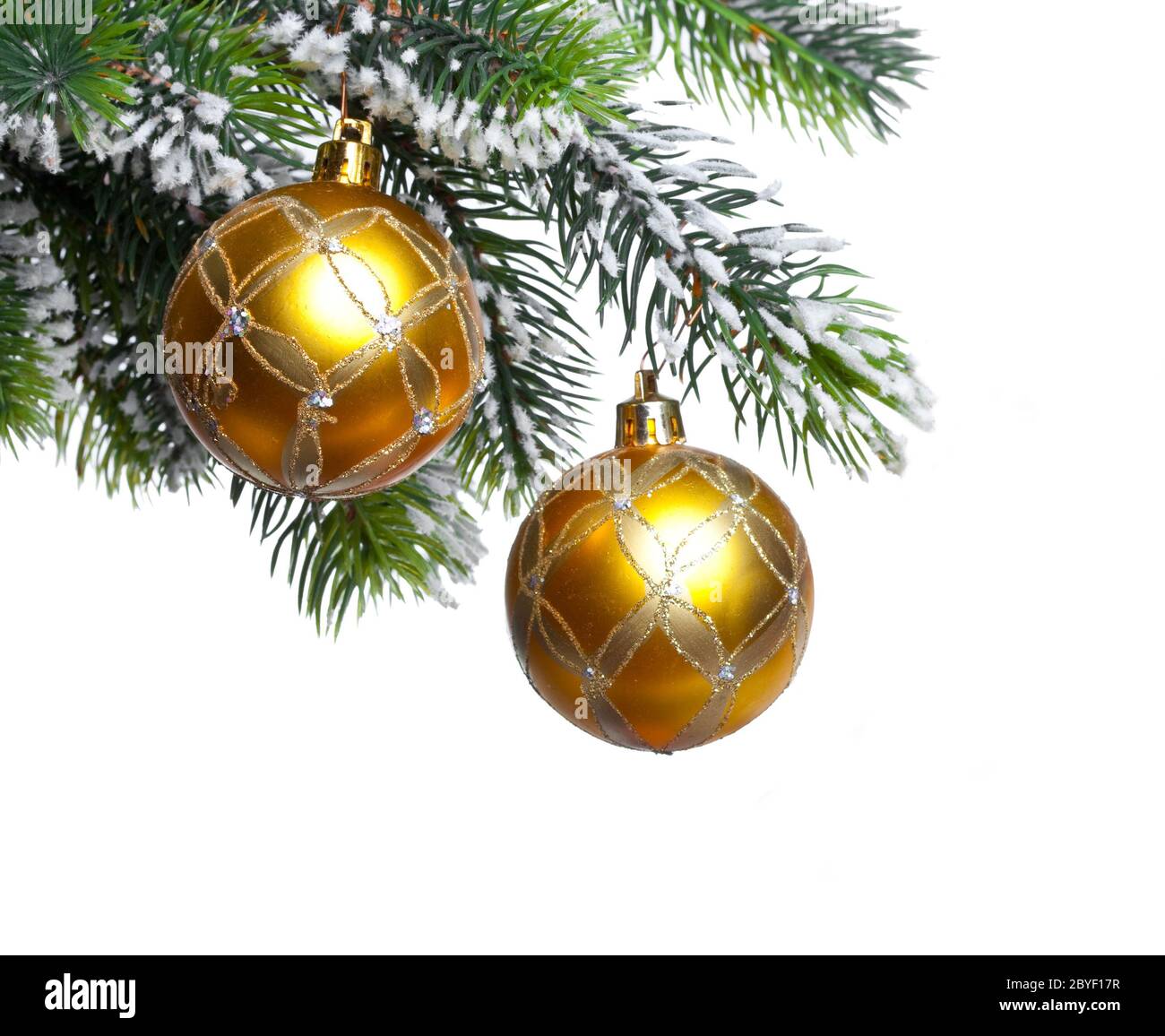 yellow New Year's balls and snow-covered branches Stock Photo