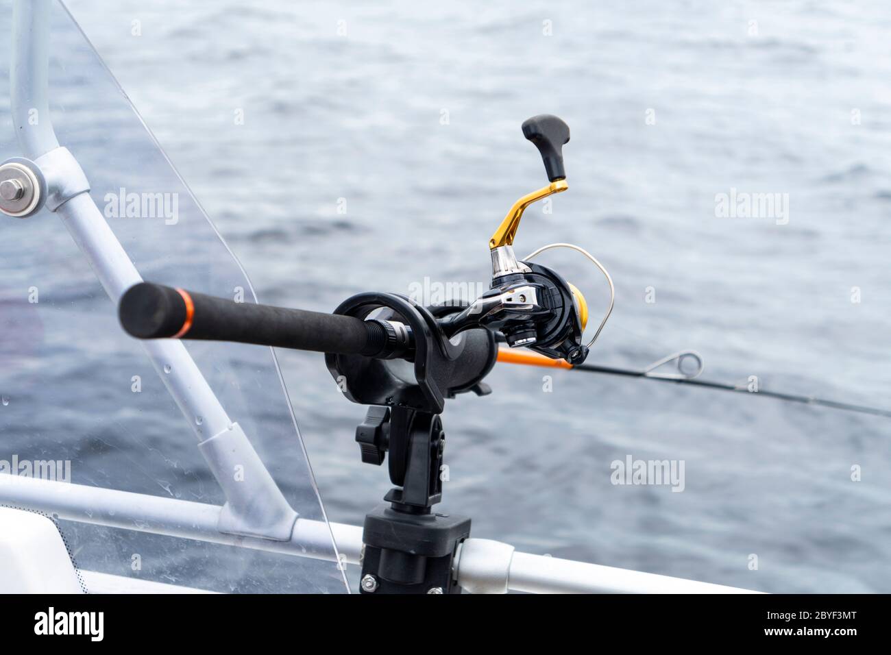 Fishing rod spinning with the line close-up. Fishing rod in rod holder in  fishing boat. Fishing rod rings. Fishing tackle. Fishing spinning reel  Stock Photo - Alamy