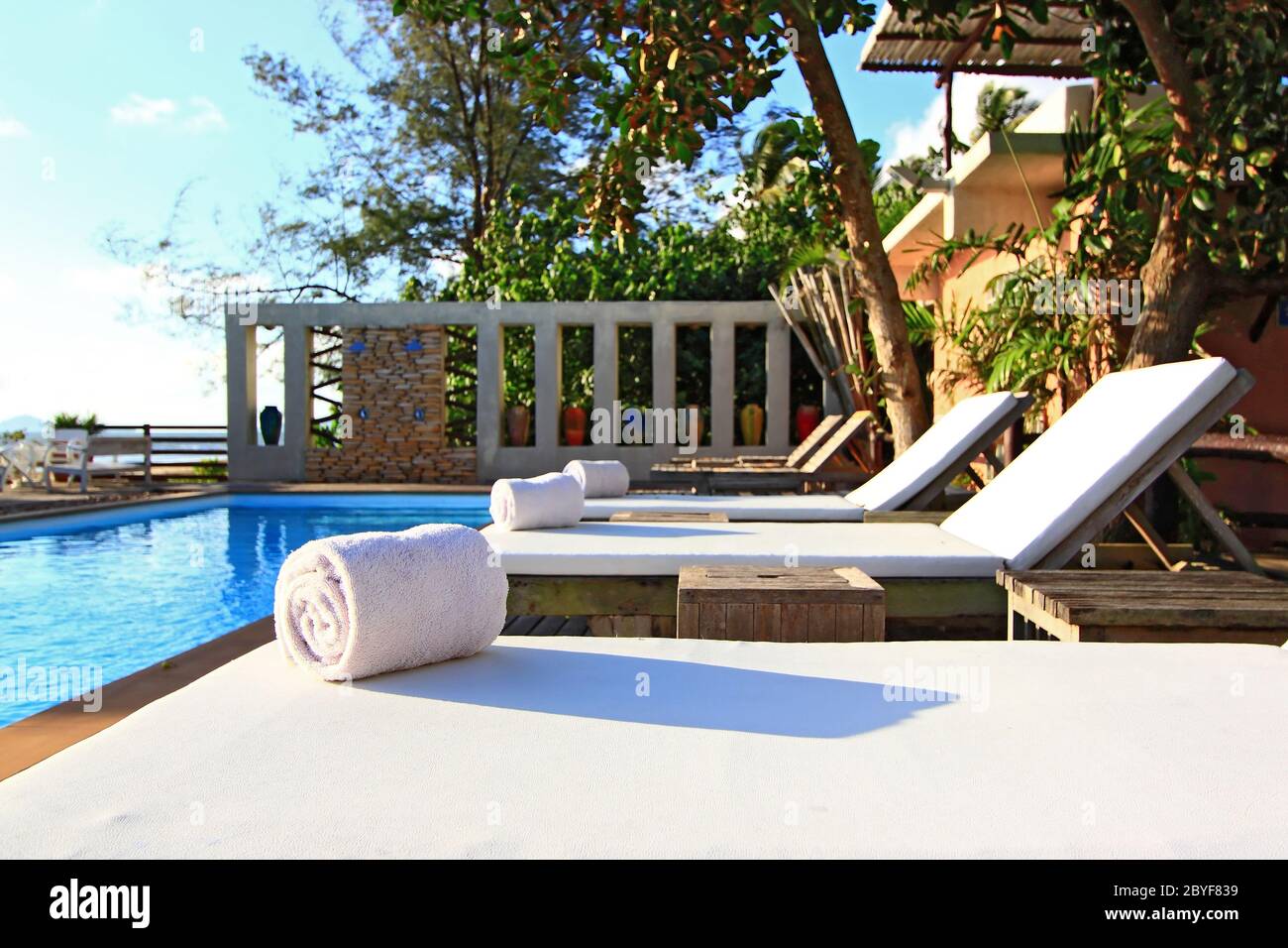 White Towel on Beach chair and Swinm pool Stock Photo