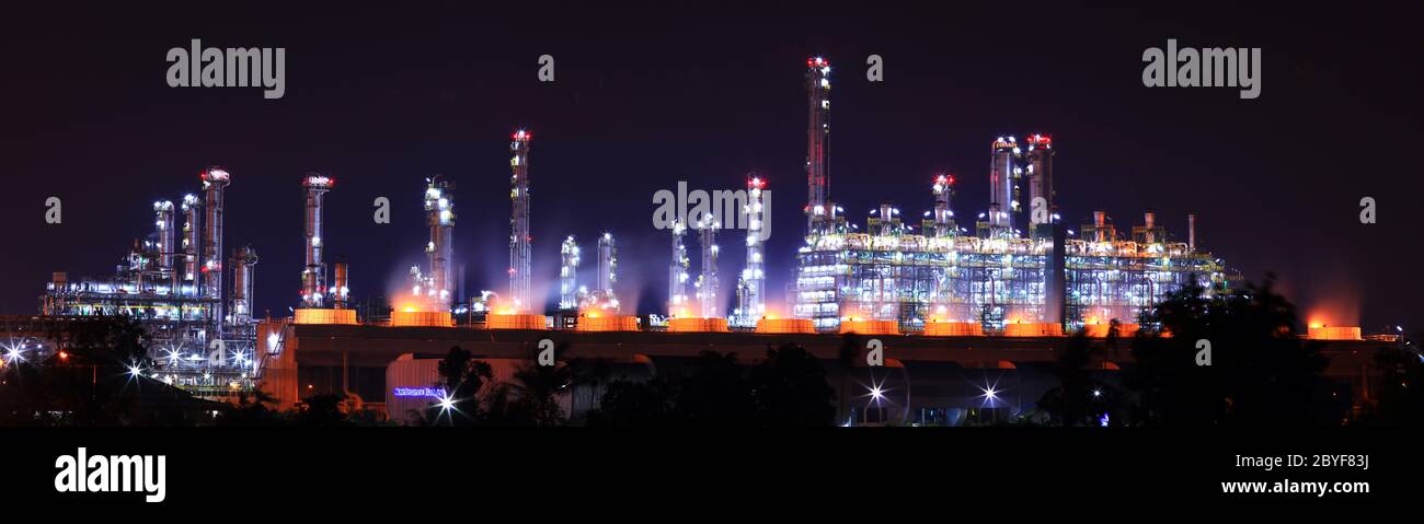 Panoramic view petrochemical oil refinery plant shines at night Stock Photo