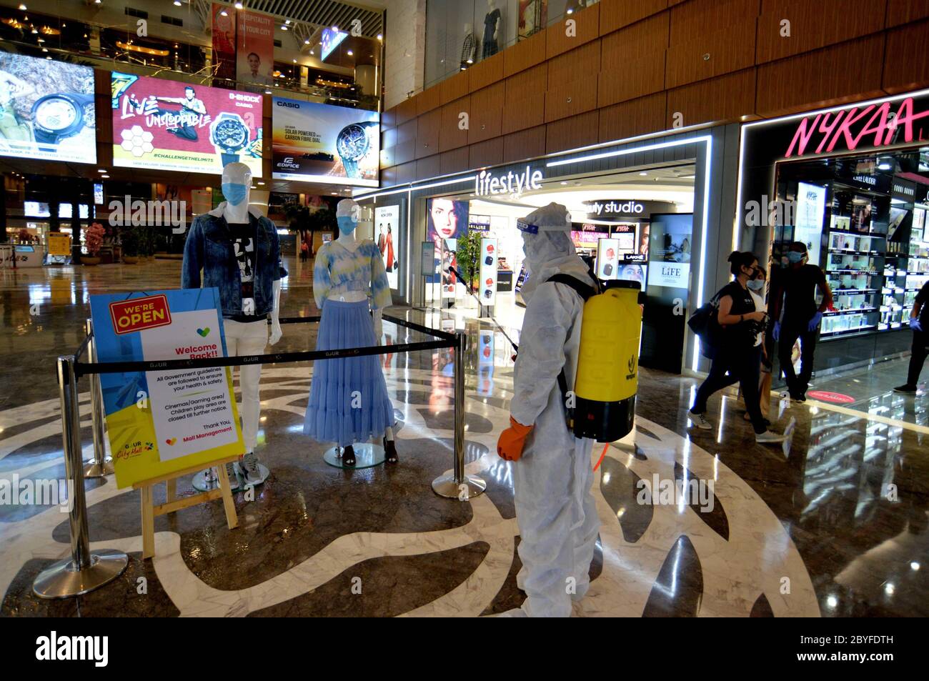 Noida. 9th June, 2020. A security guard wearing a protective suit disinfects a shopping mall at Greater Noida west in India's northern state of Uttar Pradesh, June 9, 2020. Credit: Partha Sarkar/Xinhua/Alamy Live News Stock Photo