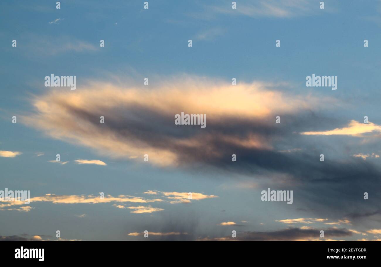 A dark cloud on a blue background Stock Photo