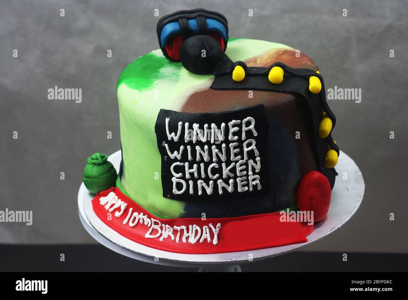 Sabah, Malaysia - 10 March 2020 : PUBG gamer inspired cake isolated with dark background. Stock Photo