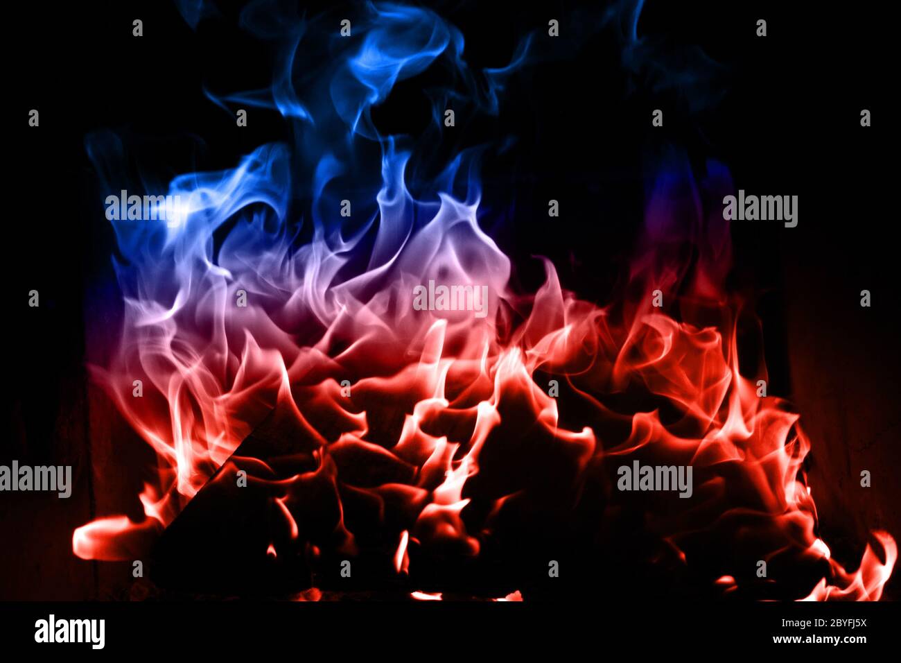 Blue and red flame isolated on dark background Stock Photo