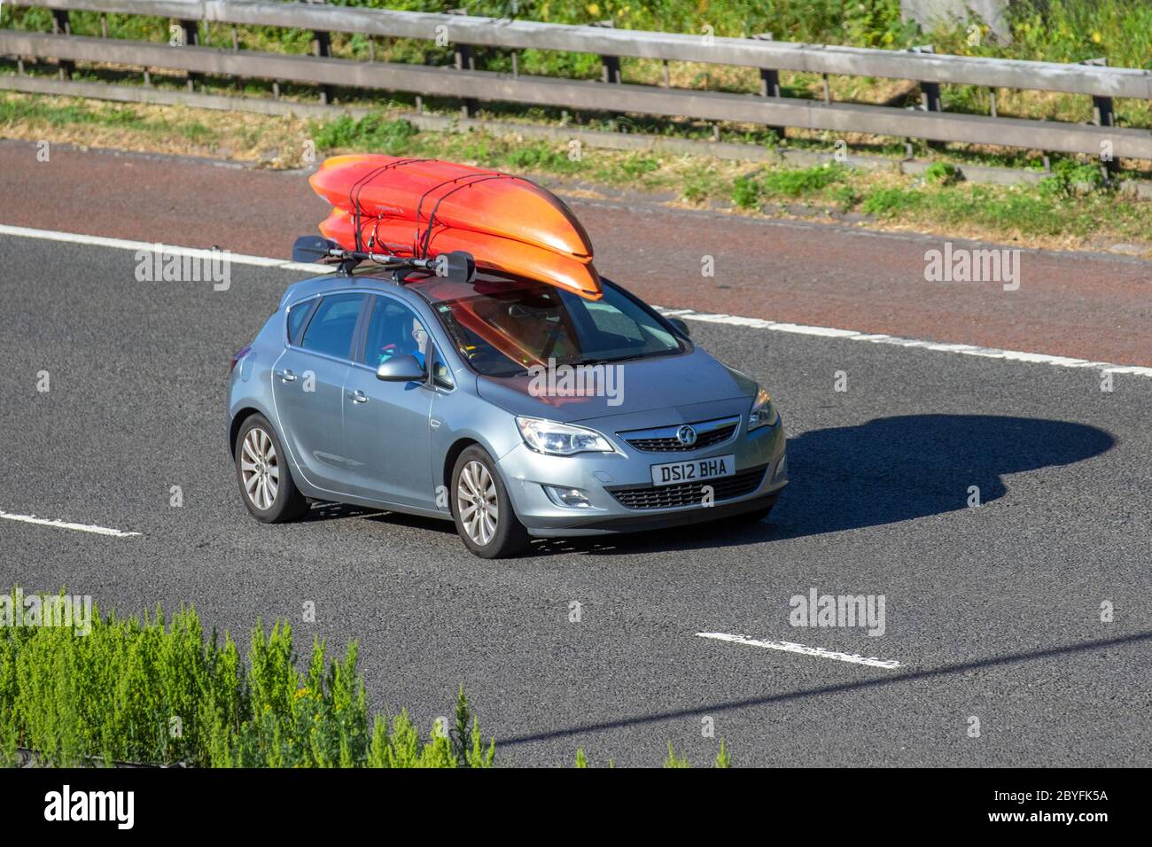 2012 silver Vauxhall Astra Elite CDTI S/S; Vehicular traffic moving vehicles, cars driving vehicle on UK roads, motors, motoring on the M6 motorway Stock Photo