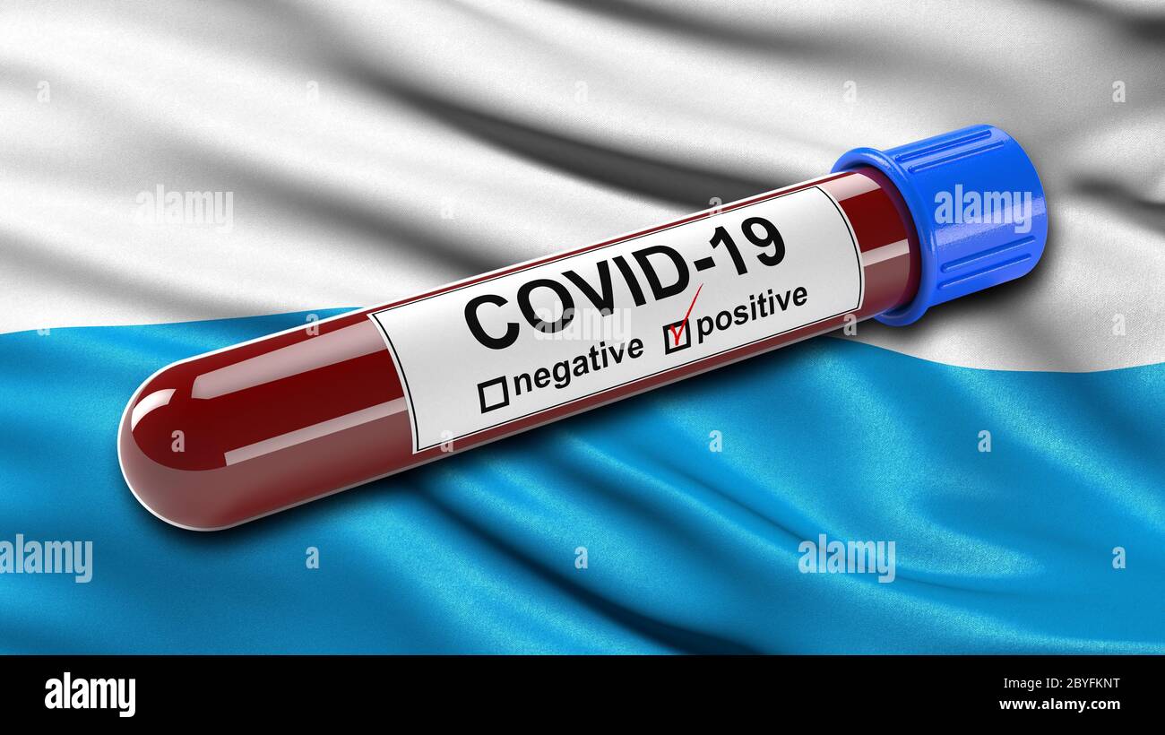 Flag of Bavaria waving in the wind with a positive Covid-19 blood test tube. Stock Photo