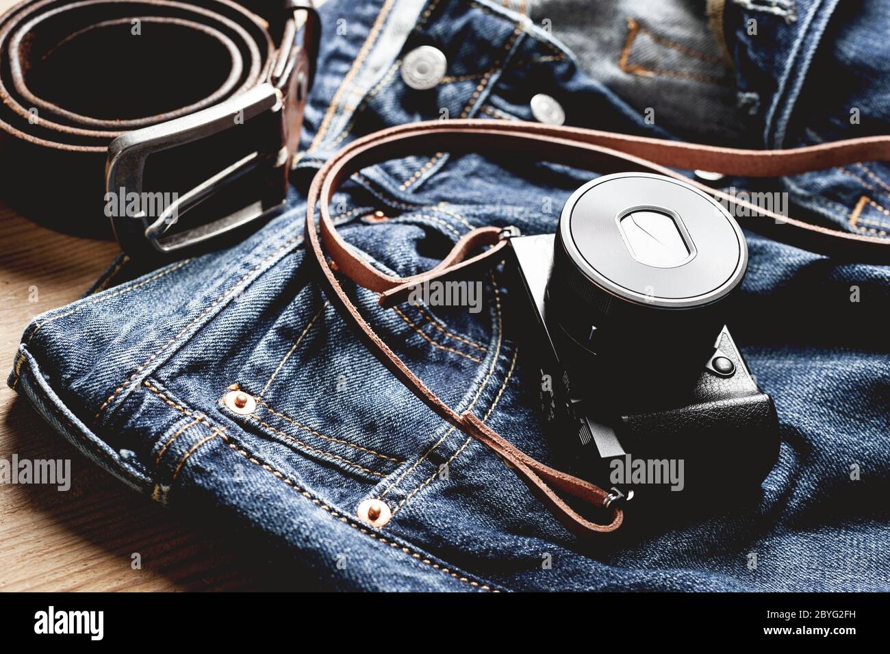 https://c8.alamy.com/comp/2BYG2FH/vintage-style-of-digital-mirrorless-camera-with-leather-strap-with-mens-accessories-and-gadgets-2BYG2FH.jpg