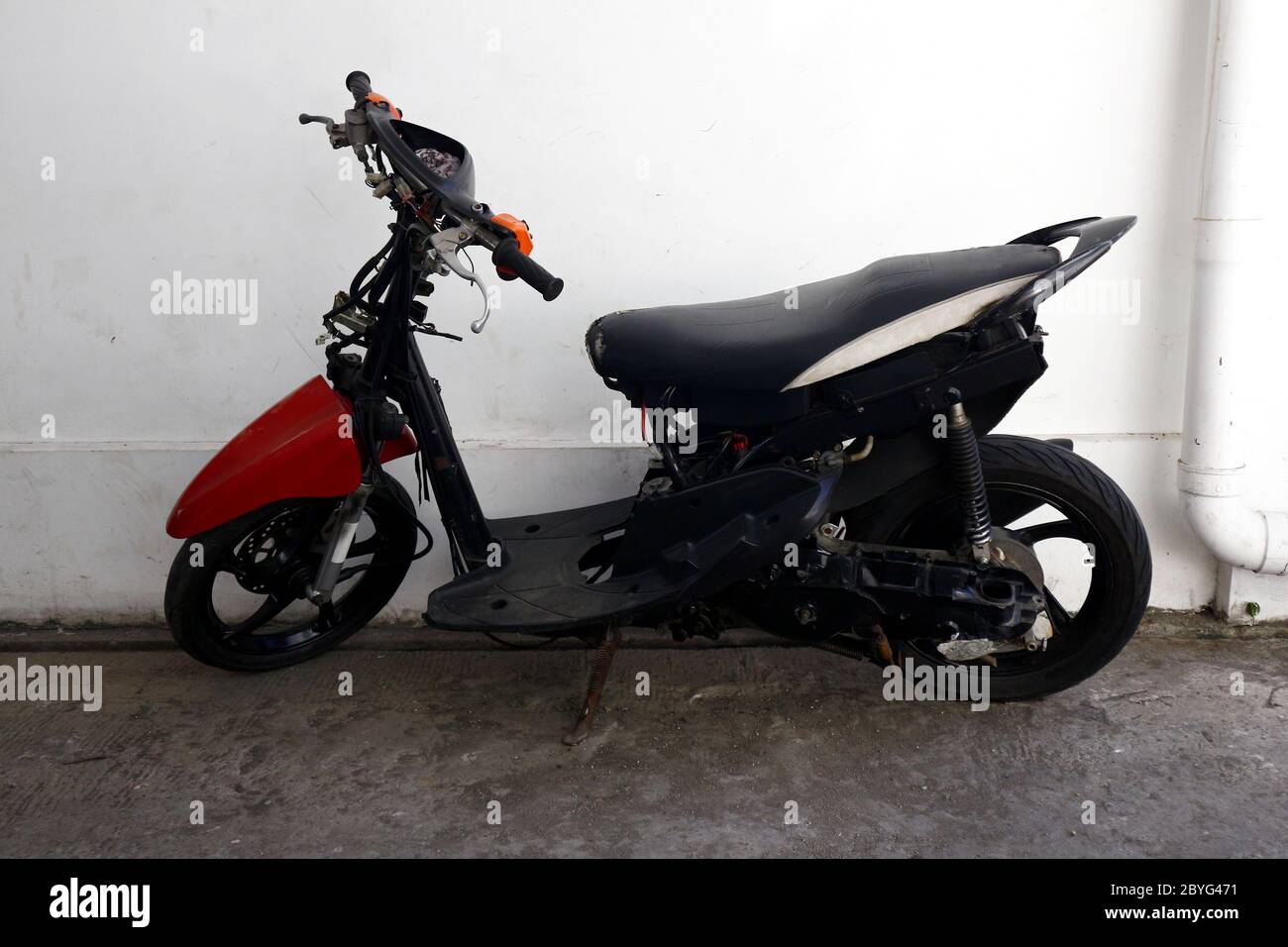 Photo Of A Stripped Down Motorcycle Scooter In A Parking Lot Stock Photo Alamy