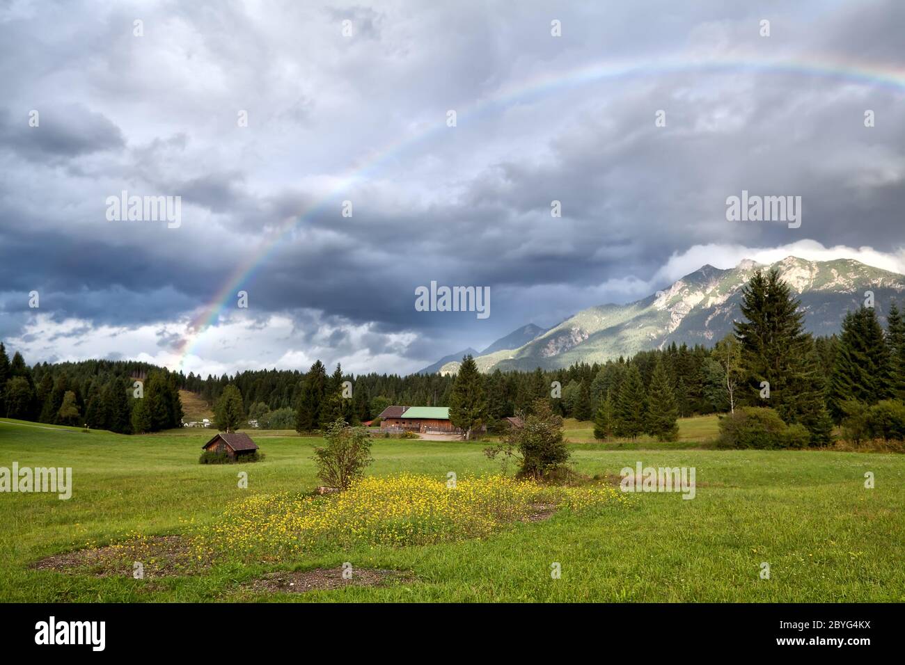 rainbow after rain in Alps Stock Photo - Alamy