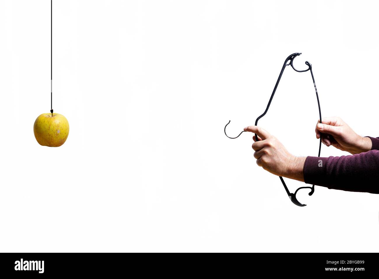As William Tell hits the apple with a bow made by a coat hanger Stock Photo
