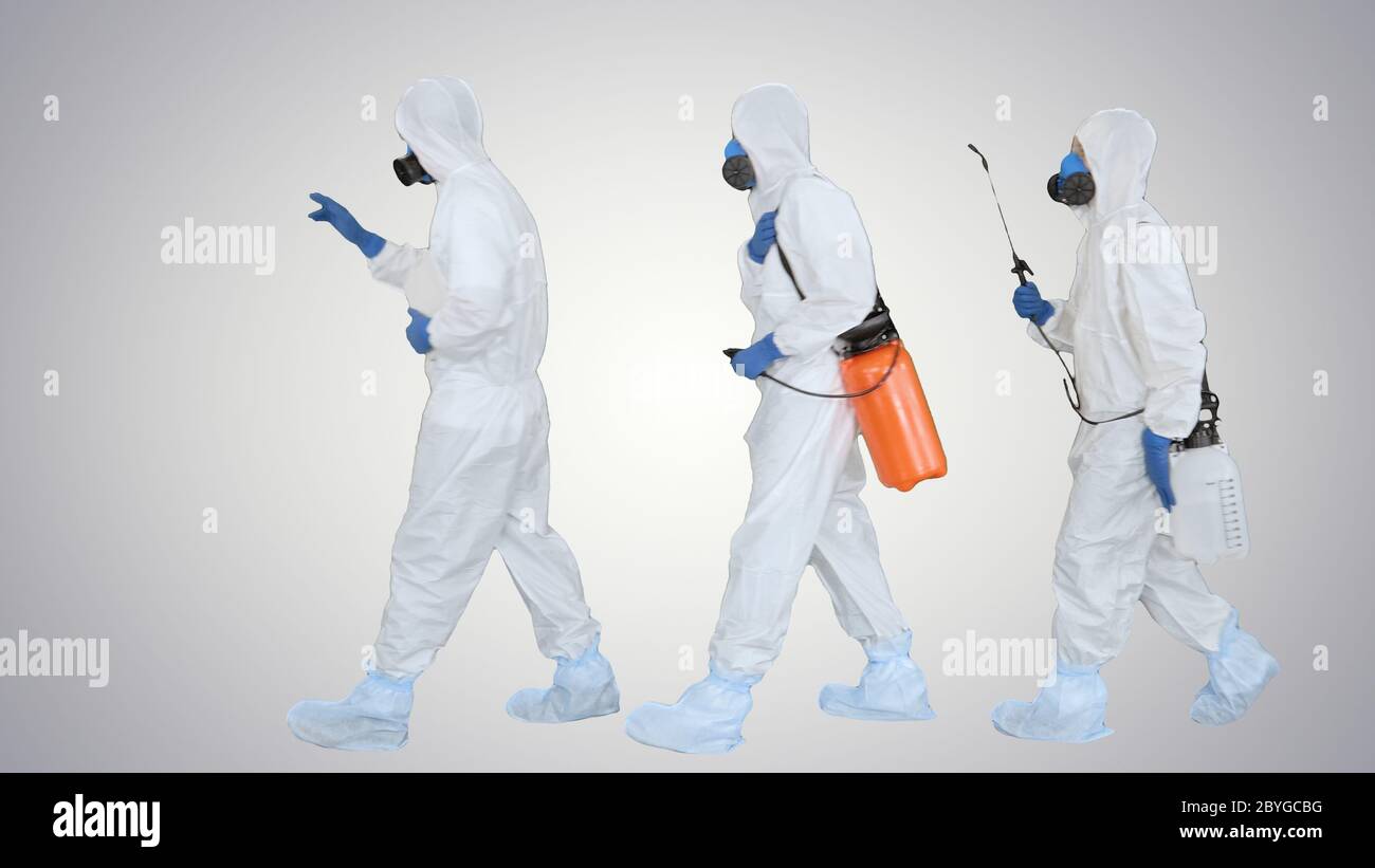 Anti coronavirus disinfection Team of virologists in hazmat suits making plan of disinfection on gradient background. Stock Photo
