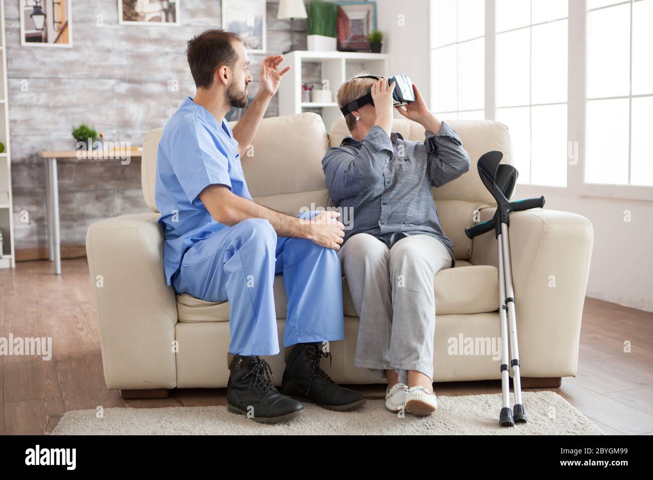 Doctor talking elderly woman crutches hi-res stock photography and ...