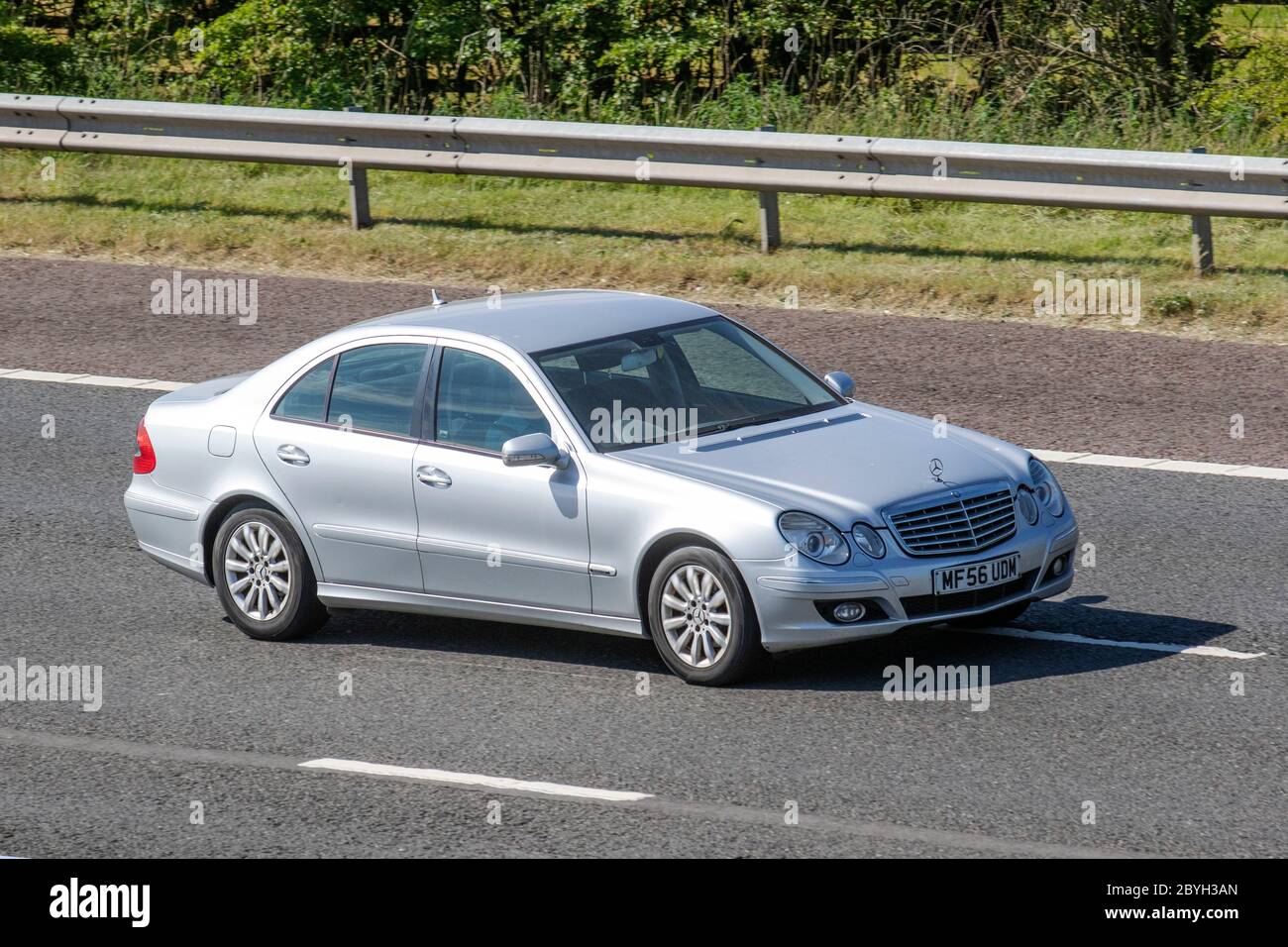 2006 silver Mercedes E280 CDI Elegance Auto; Vehicular traffic moving vehicles, cars driving vehicle on UK roads, motors, motoring on the M6 motorway Stock Photo