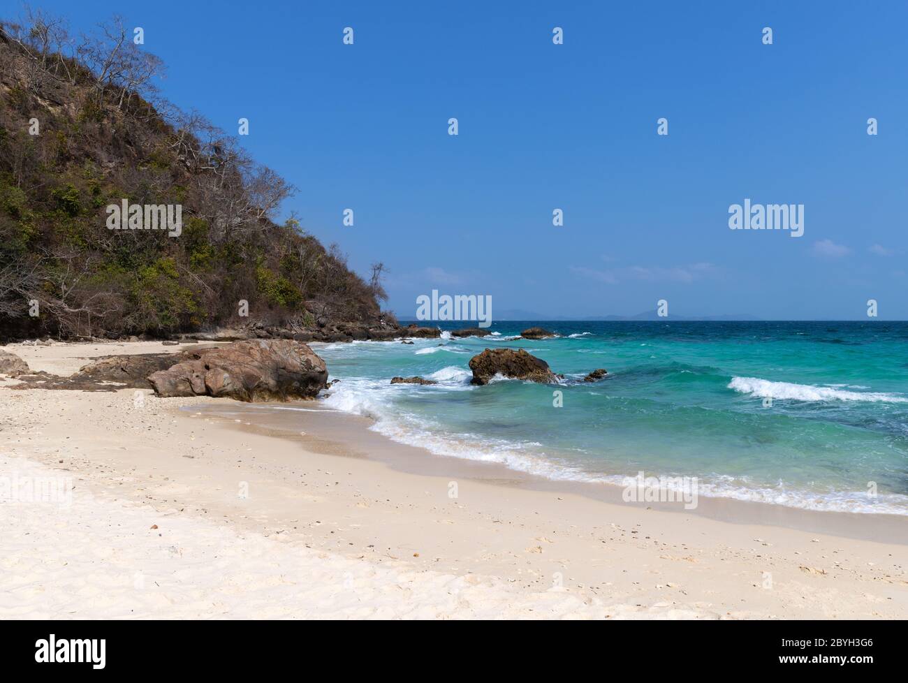Soft wave of blue ocean sea on sandy beach Stock Photo