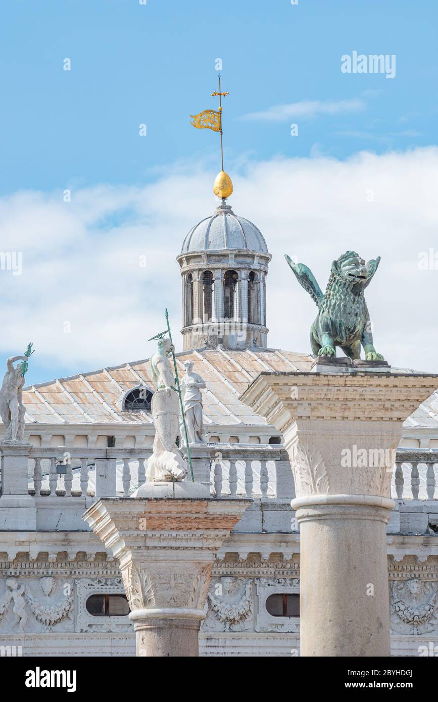 View over San Marco square roof top towers, sculptures and the symbol of Venice a winged lion at Doge Palace, Venice, Italy, summer Stock Photo