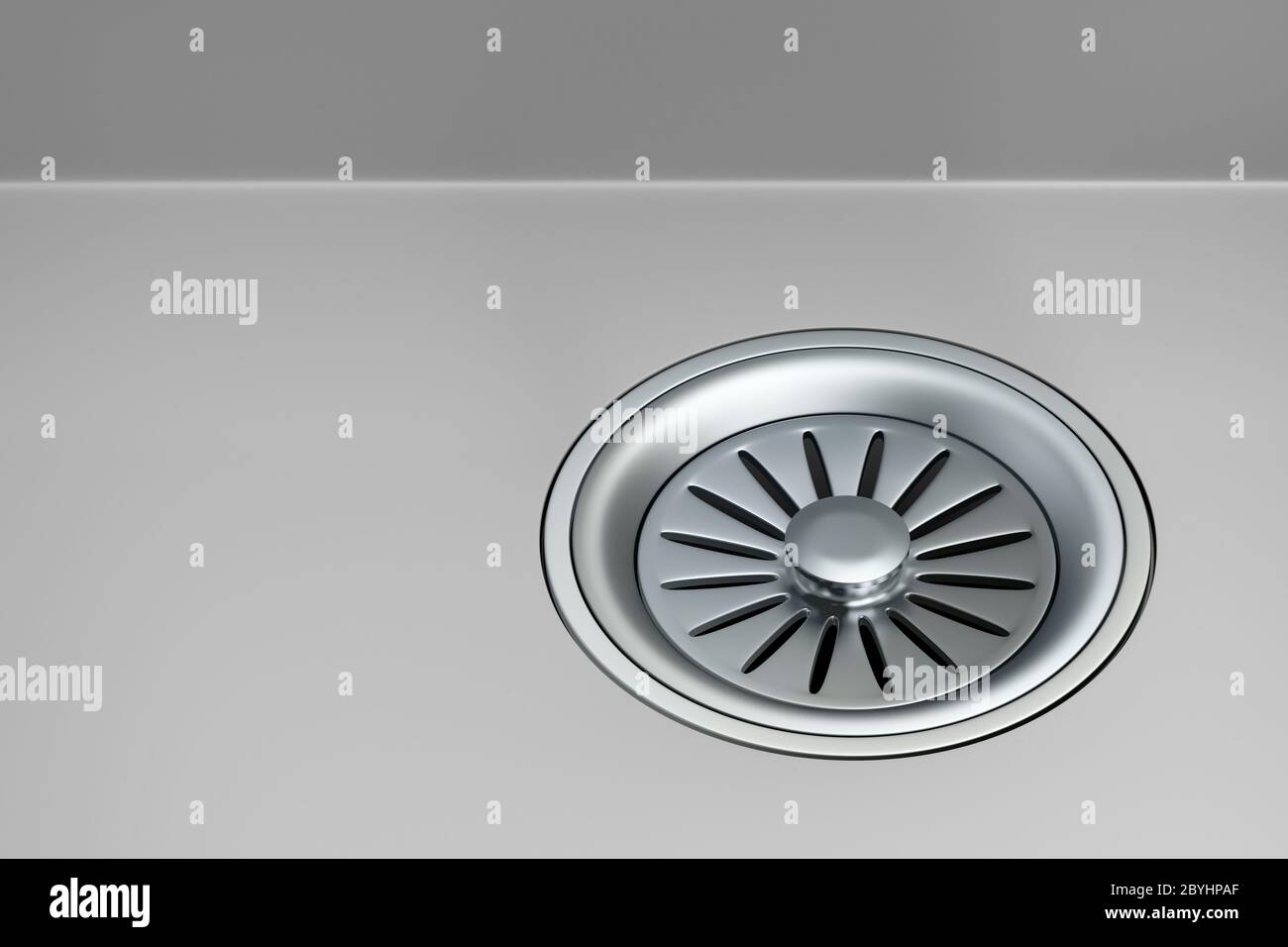 Stainless steel sink strainer with stopper installed on gray sink Stock