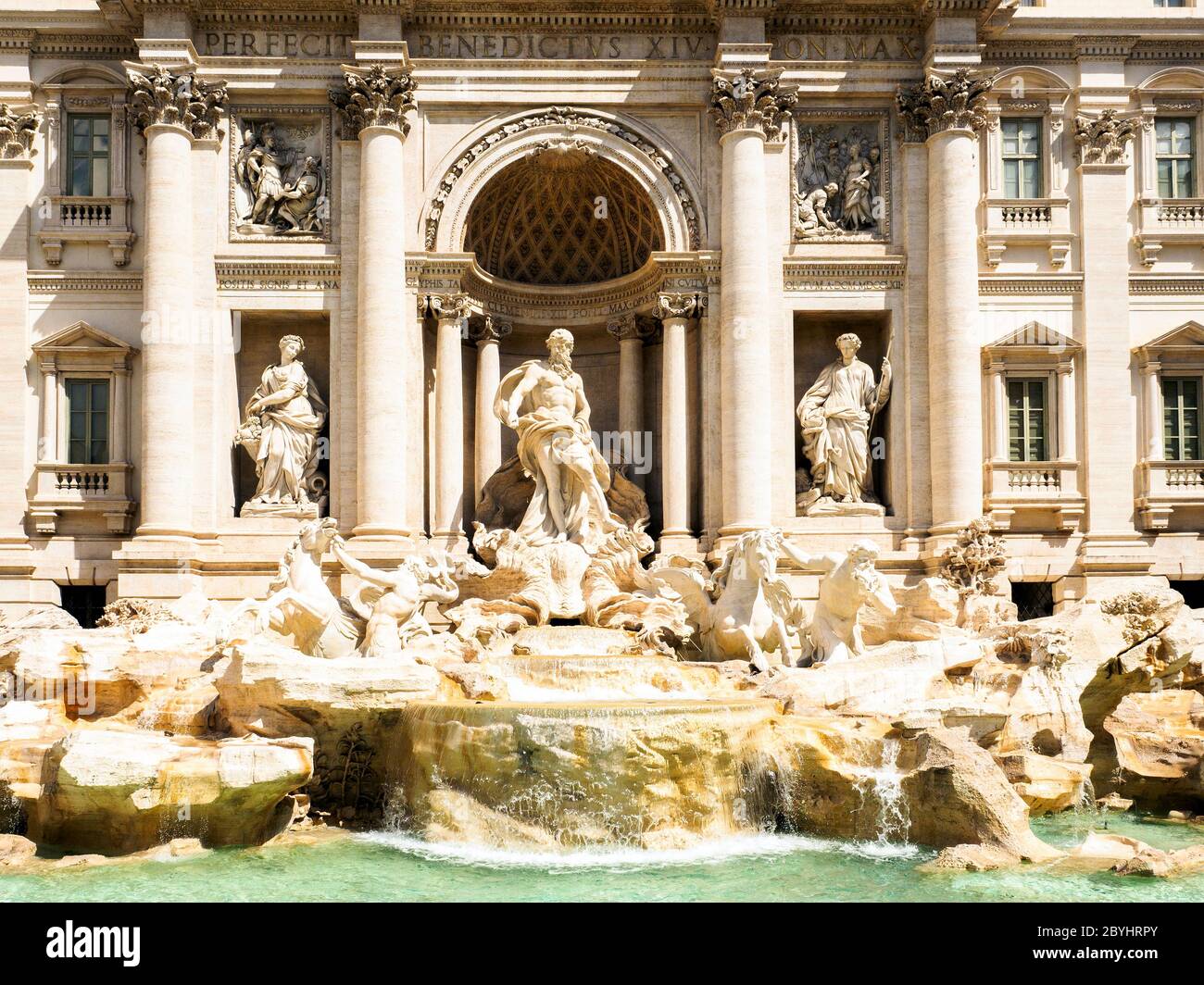 Statuary group of Trevi fountain. In the centre the statue of Ocean on a shell-shaped cart, pulled by two sea horses, one 'Placid' (right) and the other 'Agitated' (left), to symbolize the two aspects of the sea, and guided by as many tritons and in the two lateral niches the two statues depicting Abundance (left) and Health (right) - Rome, Italy Stock Photo