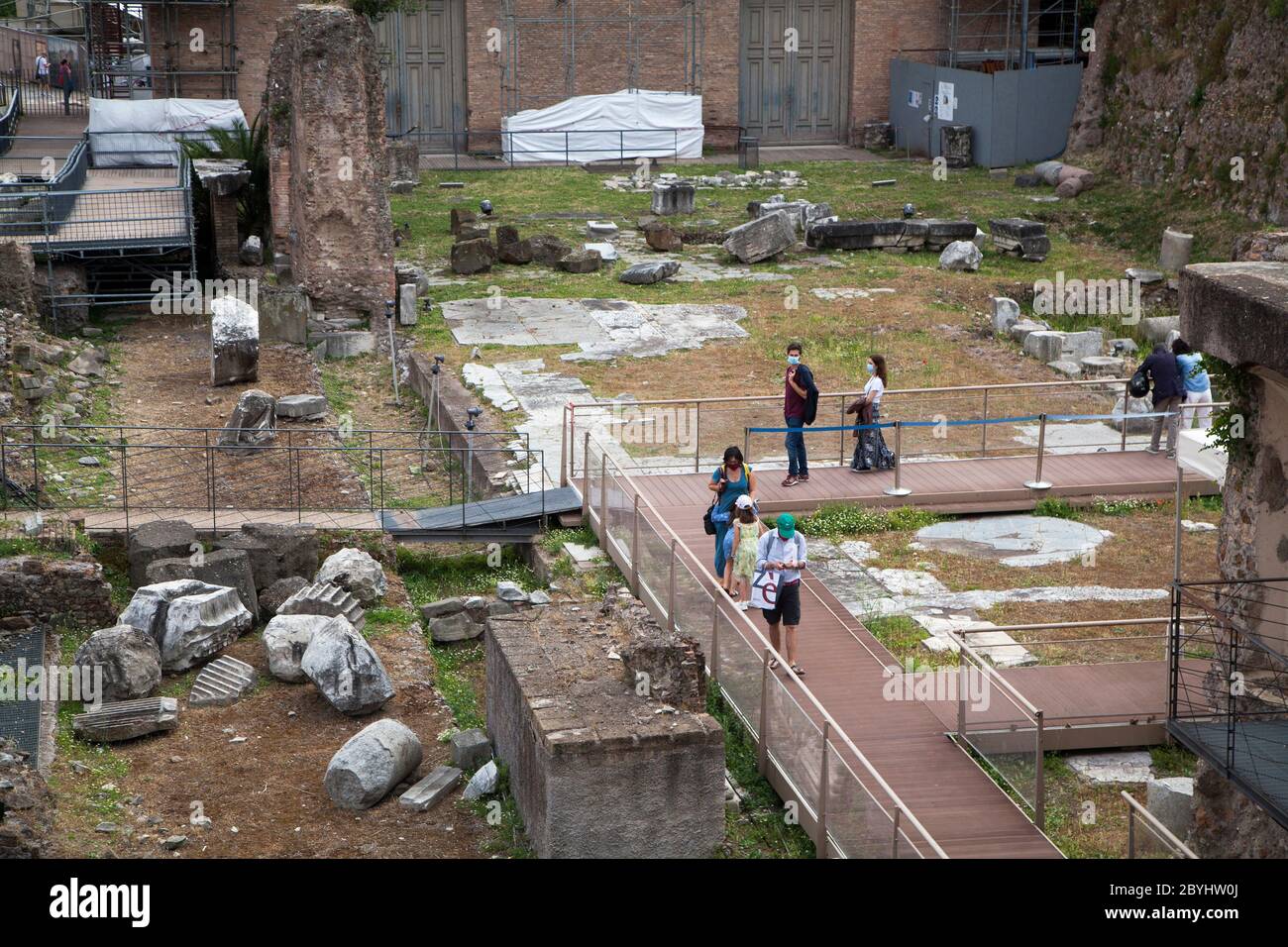 Still few tourists in Rome after Covid19 lockdown. People wearing a protective face mask visits Fori Imperiali Area in Rome, Italy, on Tuesday, June 02, 2020. Stock Photo