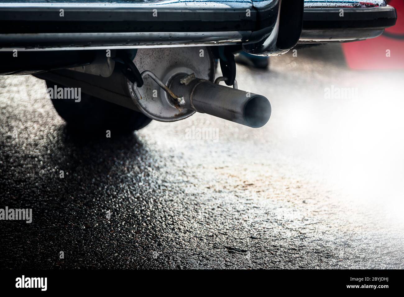 combustion fumes coming out of car exhaust pipe, exhaust gas from a car