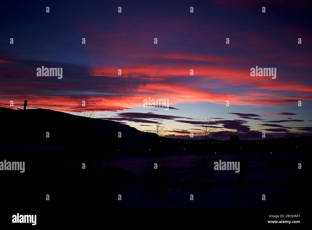 Silhouette of Kiruna iron ore mine with pink twilight sky in the background Stock Photo