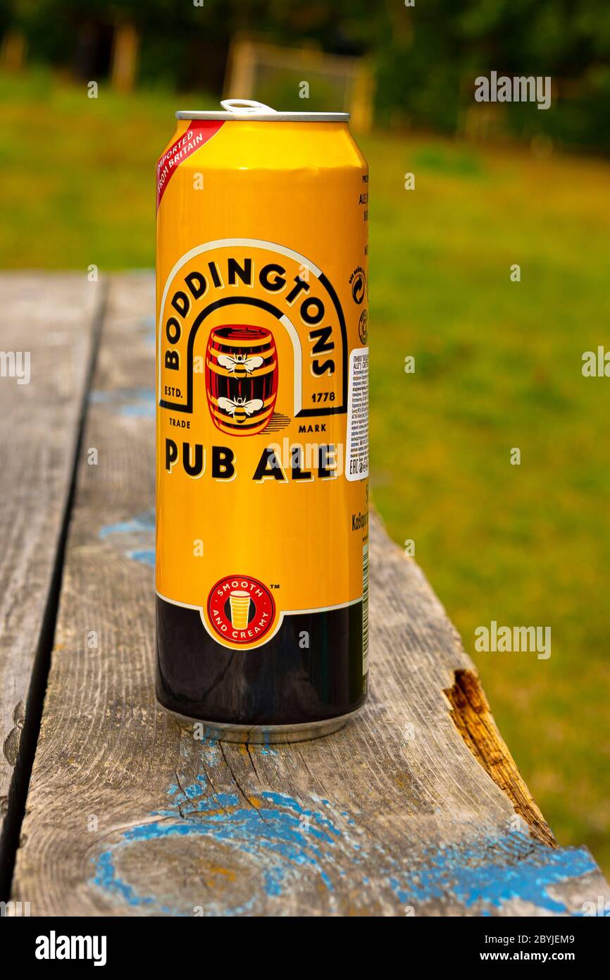 Sankt-Petersburg, Russia - July 10 2019: Can of Boddingtons Draught Bitter on the backyard bench. Boddingtons is brewed at Strangeways Brewery in Manc Stock Photo