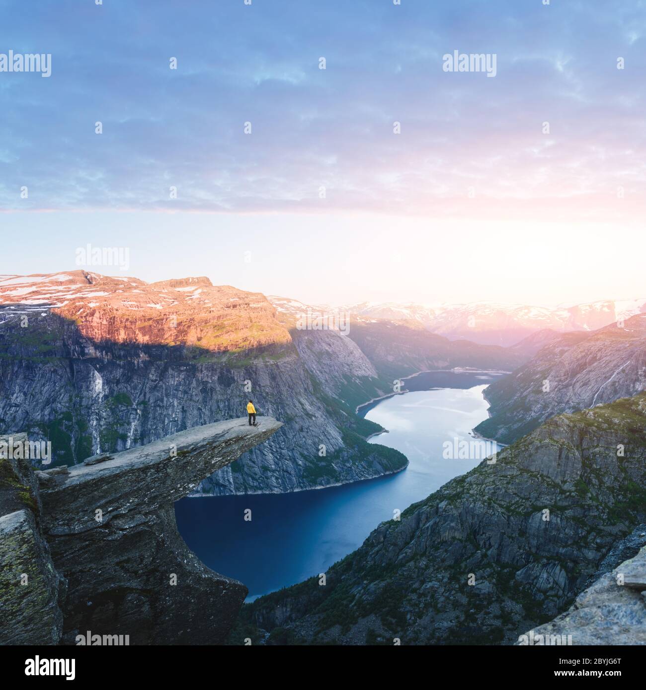Troll Rocks Noway Tourist on Trolltunga rock in Norway mountains. Landscape photography ...