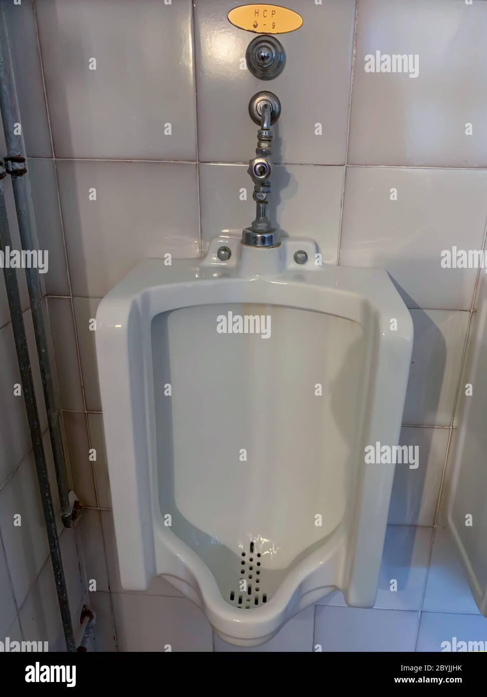 Urinal in Bathroom with Handicap Placard for Golfer in Italy Stock