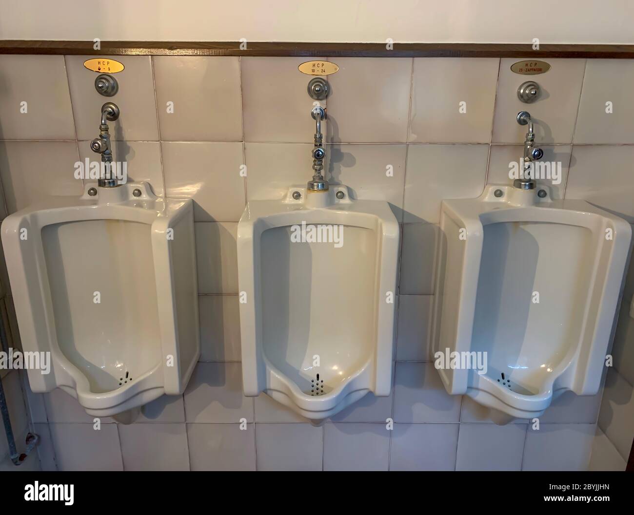 Urinal in Bathroom with Handicap Placard for Golfer in Italy Stock