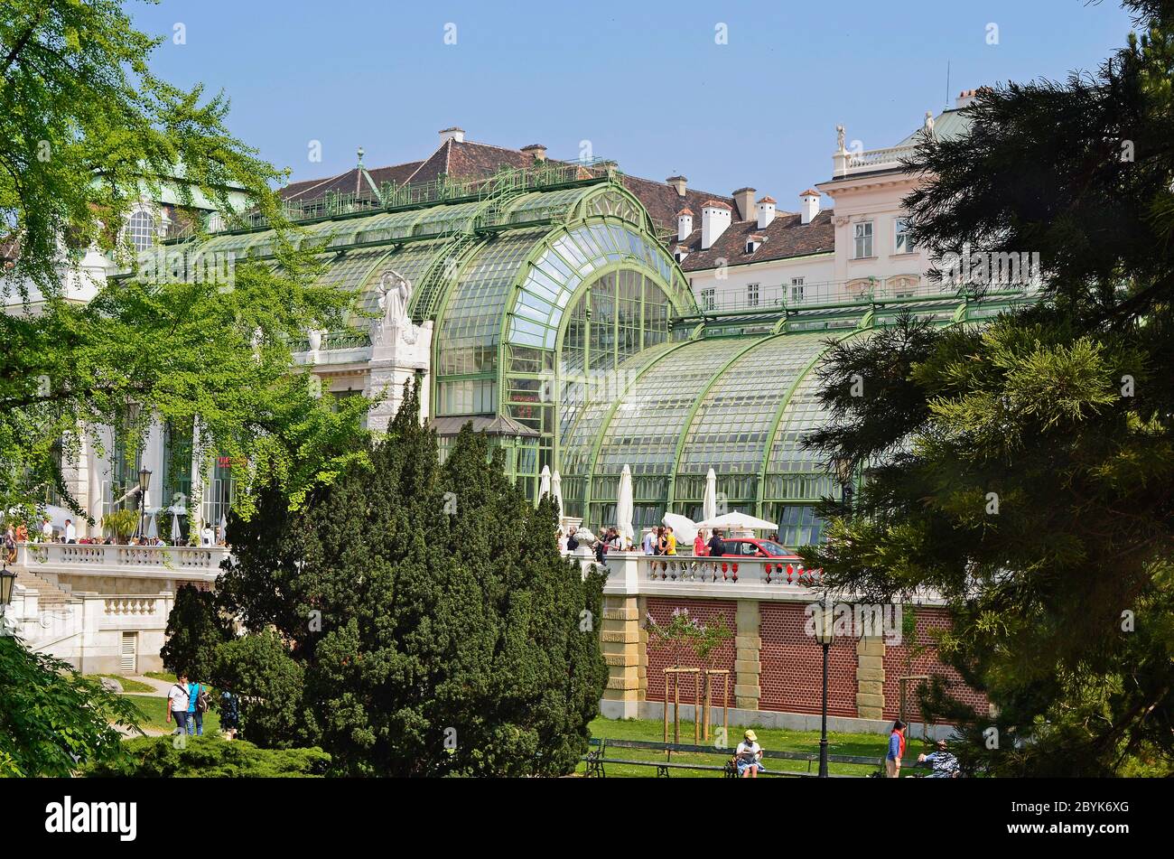 Vienna, Austria - April 24th 2011: unidentified people walk and take a rest on the way in front of the new renovated palm house cafe in public Burggar Stock Photo