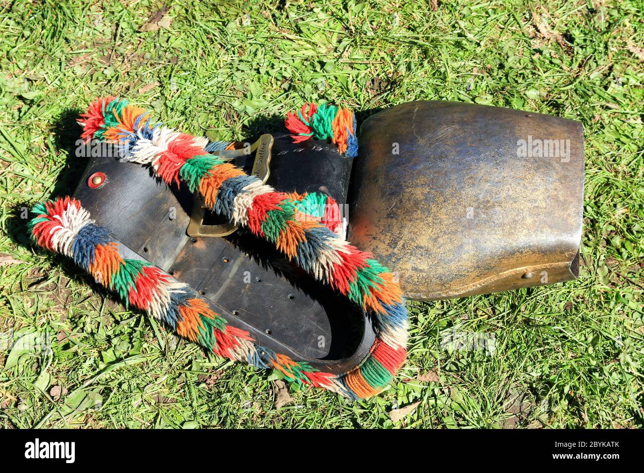 BAD HINDELANG, BAVARIA, GERMANY - SEPTEMBER 10 2011: Huge colorful cowbell lying in the grass at the traditional annual Almabtrieb, Viehscheid in Stock Photo