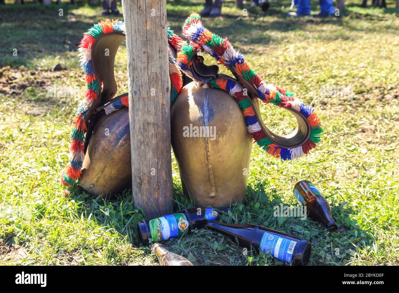 BAD HINDELANG, BAVARIA, GERMANY - SEPTEMBER 10 2011: Huge colorful cowbell and empty beer bootles on the ground at the traditional annual Almabtrieb Stock Photo