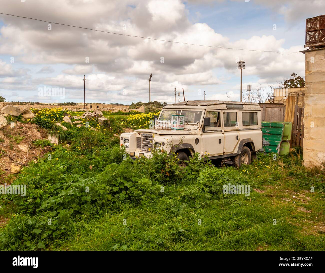 Overgrown Land Rover in Malta Stock Photo