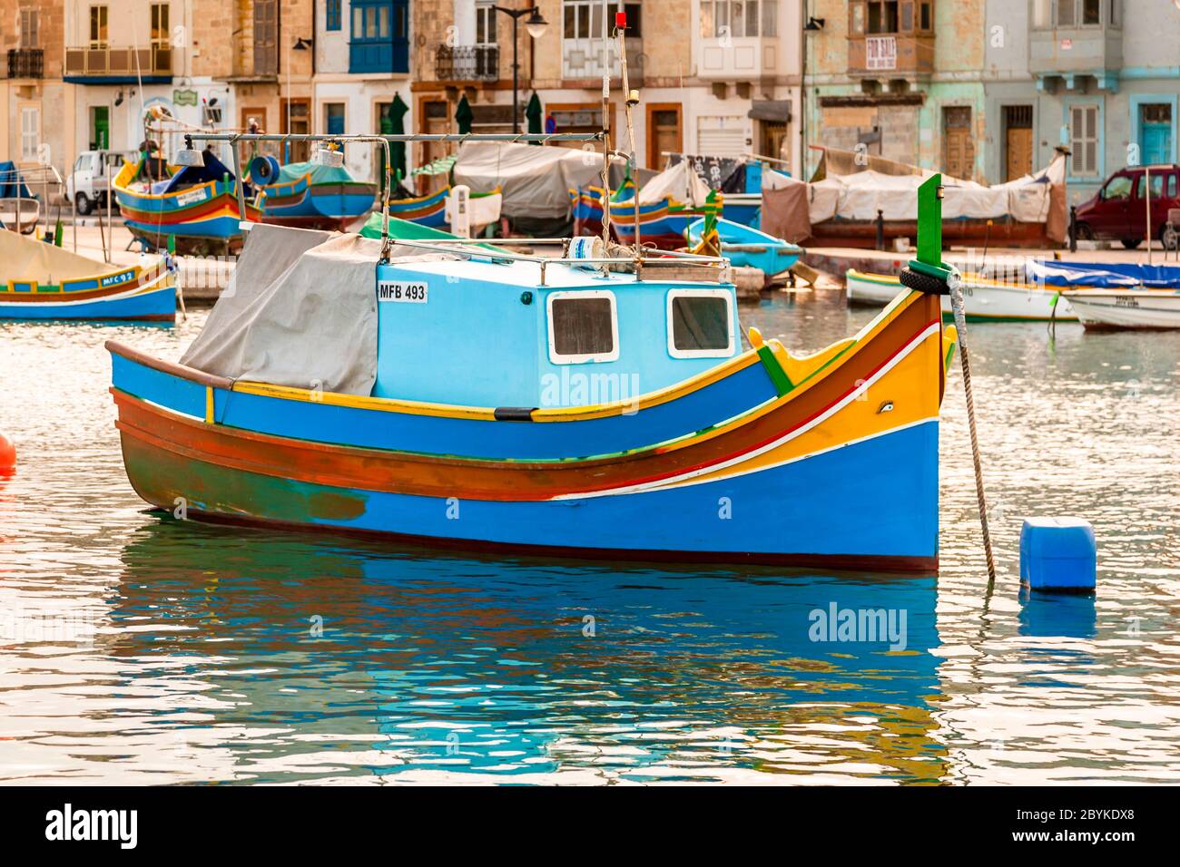 Colorful Boats at fishing port in Marsaxlokk, in the southeast of Malta. There are ports large and imposing like that of the capital Valetta, but small fishing ports characterize the varied coast of Malta and Gozo Stock Photo