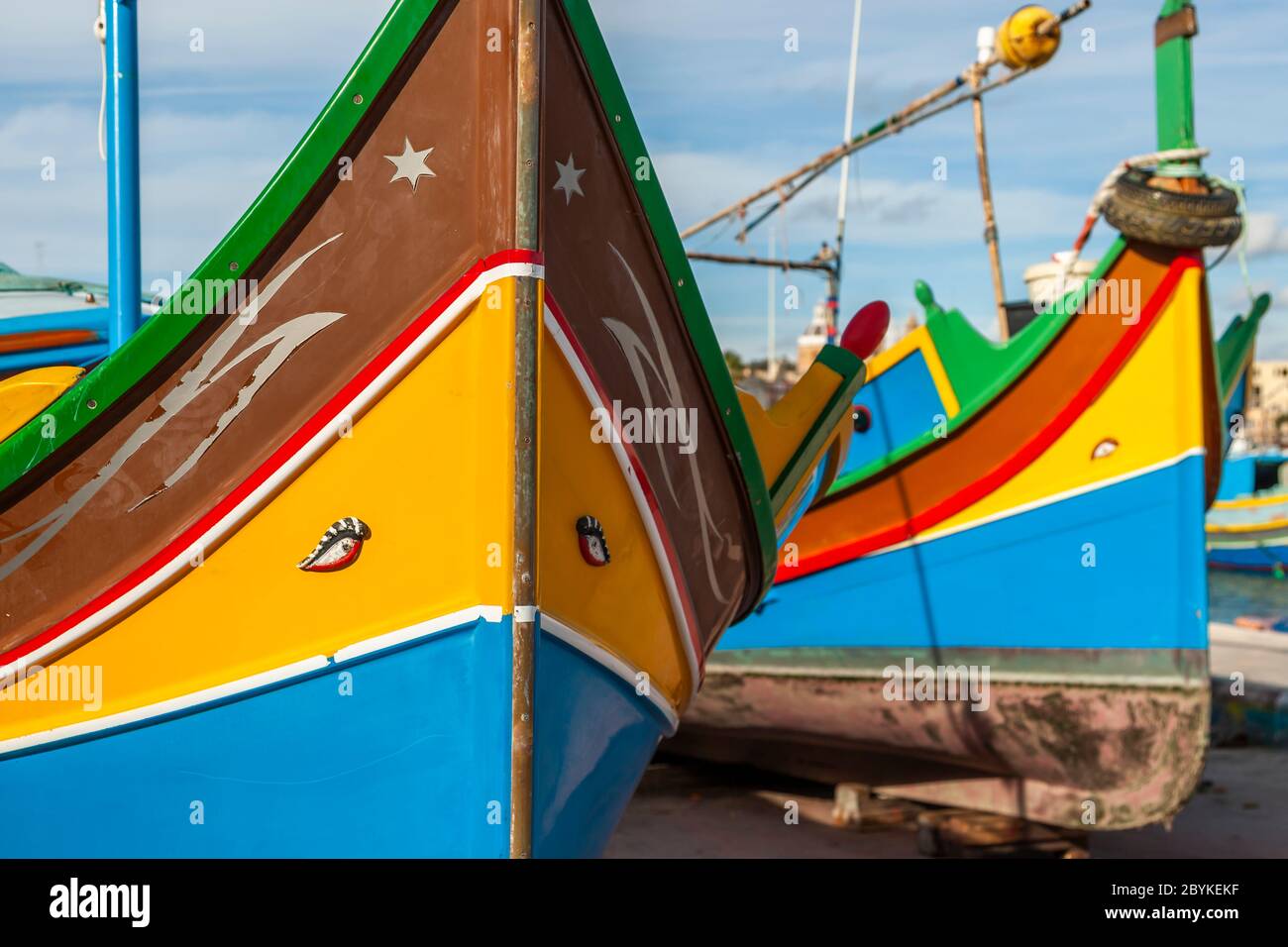 Colorful Boats at fishing port in Marsaxlokk, in the southeast of Malta. There are ports large and imposing like that of the capital Valetta, but small fishing ports characterize the varied coast of Malta and Gozo Stock Photo