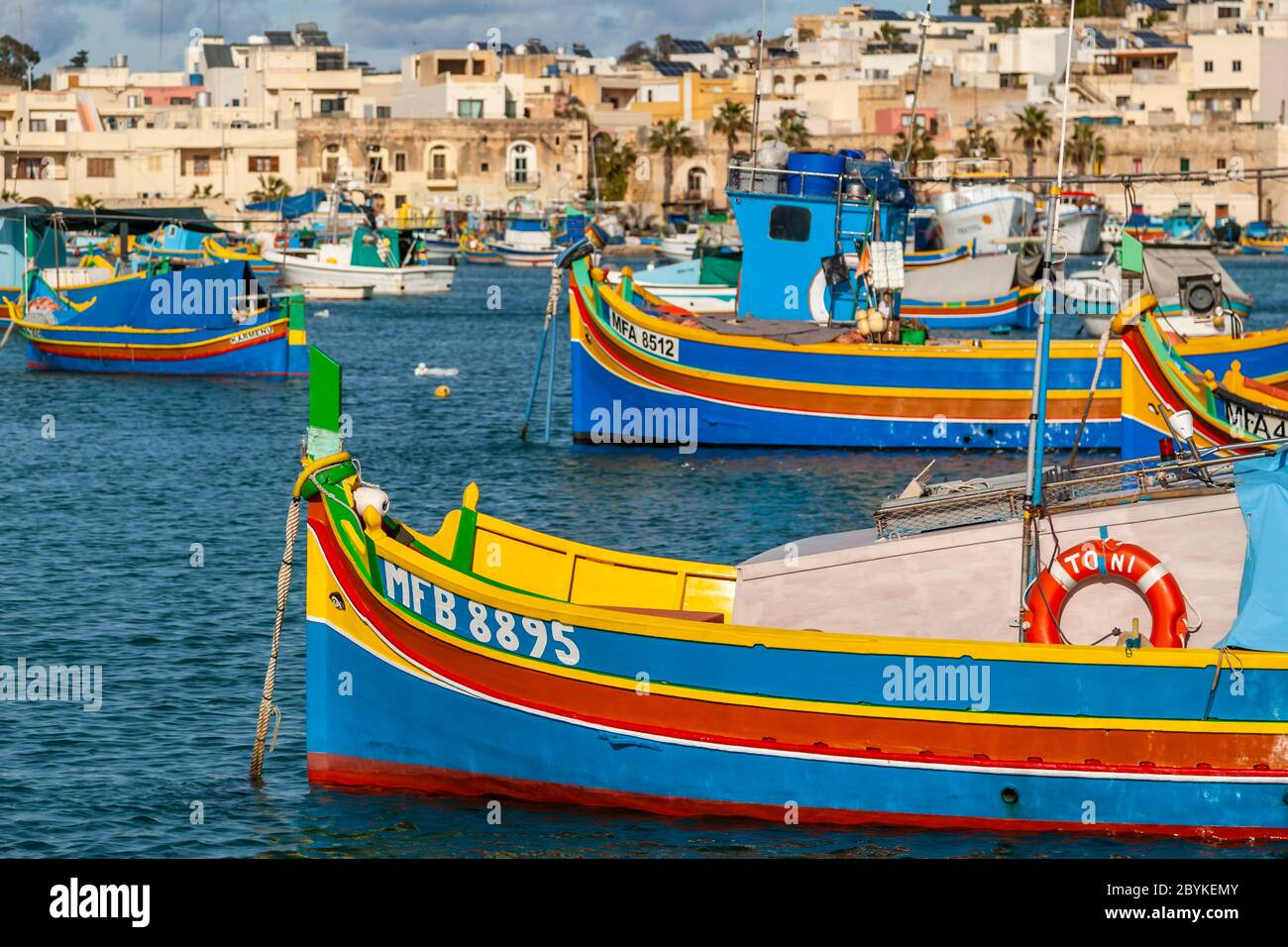 Fishing port in Marsaxlokk, in the southeast of Malta. There are large and imposing harbors like the one of the capital Valetta, but mainly small fishing ports characterize the varied coast of Malta and Gozo Stock Photo