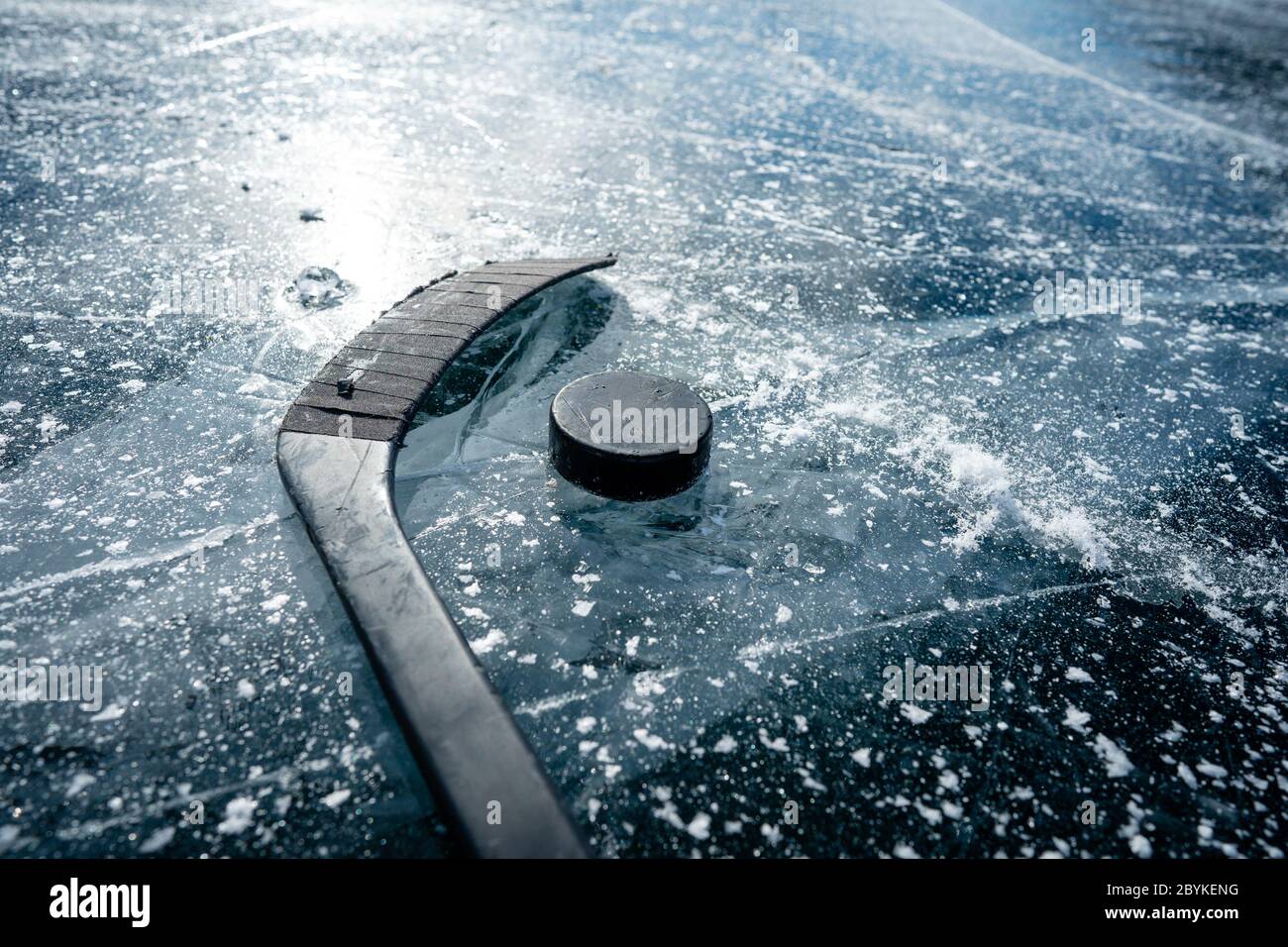 Details close up hockey puck on a frozen pond. Ice skating in nature at  sunset in winter. Travel and sports Stock Photo - Alamy