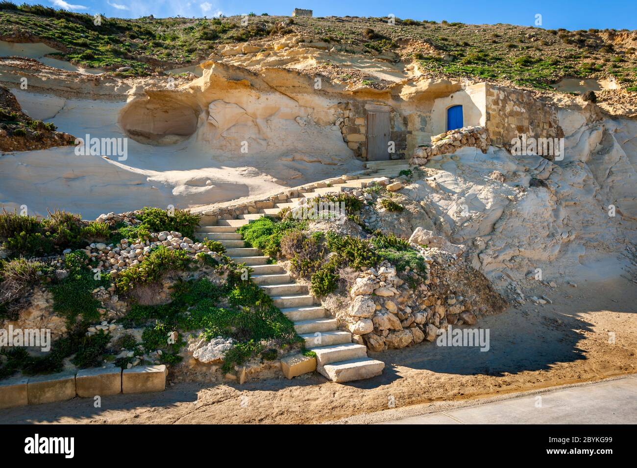 Gozo Sea Salt Production in Żebbuġ, Malta. In summer, the salt is sold directly from the small storage rooms carved into the limestone. Here the salt extracted from the sea is also packed Stock Photo