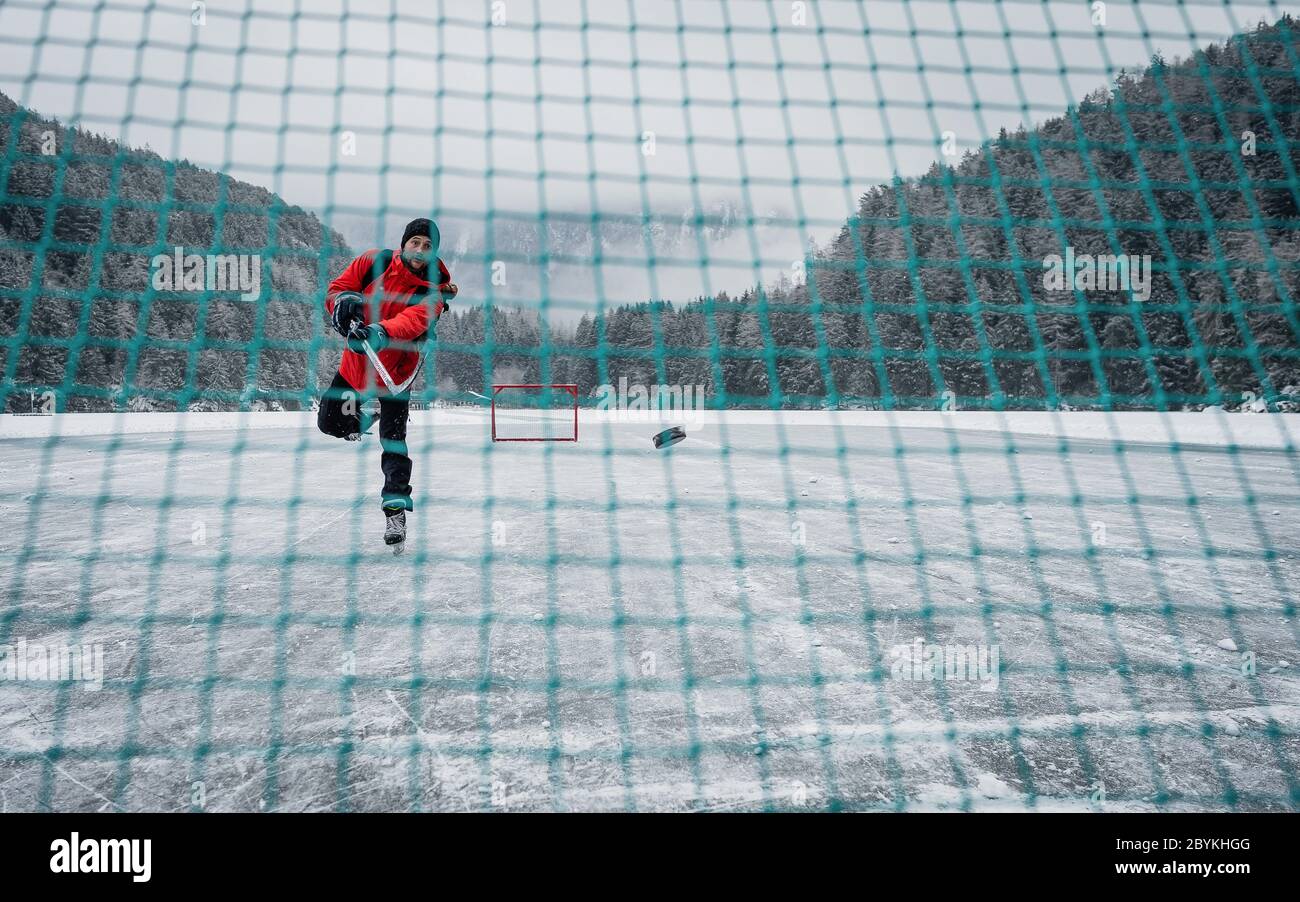 Ice hockey training. Crossed hockey nets in goal net with ice. Frozen