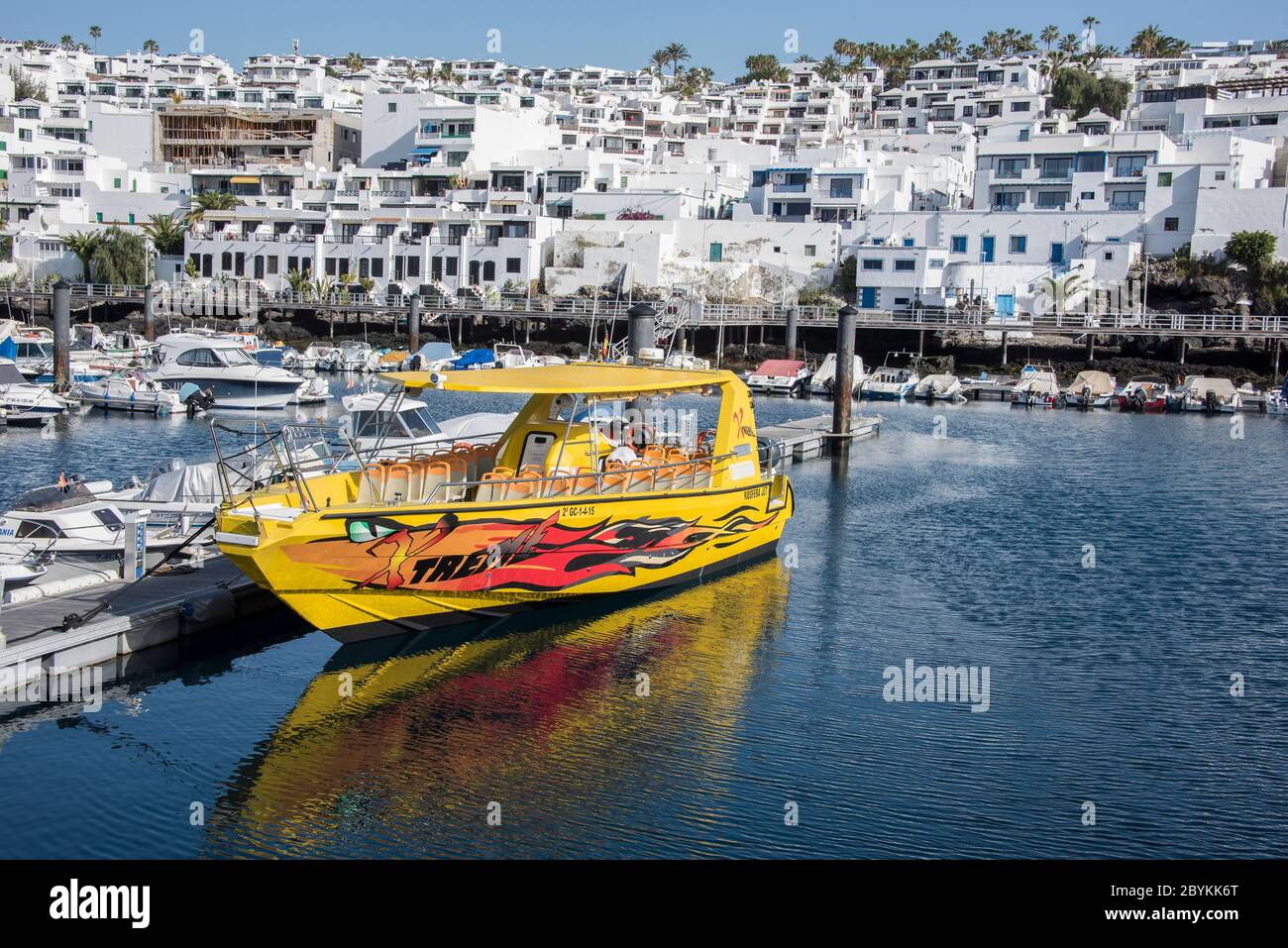 Yellow Treme Biosfera Jet berthed at Old Town Harbour, Puerto Del Carmen, Lanzarote, Canary Islands, Spain Stock Photo