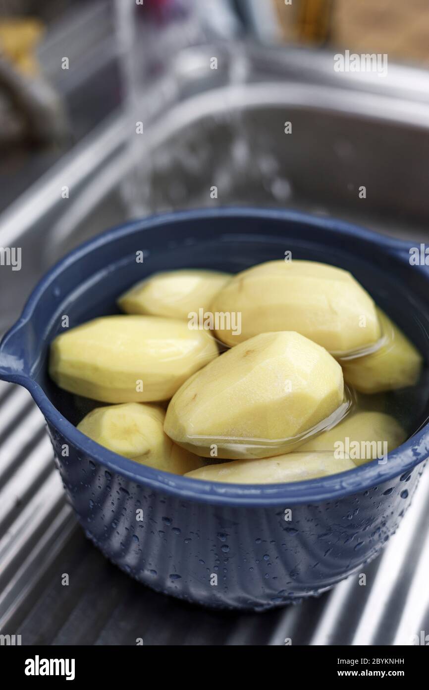 Washed and peeled organic potatoes. Stock Photo